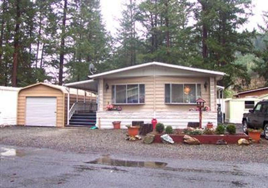 Desirable 55 & over park. Well maintained doublewide. Living room plus family room with pellet stove. So many closets and cupboards I lost count! Kitchen is open to family room and has a side by side refrigerator. Built in buffet in dining area. Slider to covered porch. There are two storage sheds plus a one car 24'x12' garage. Indoor laundry with 2 year old washer dryer included. Park rent is currently $155, will be $175 as of May 1.