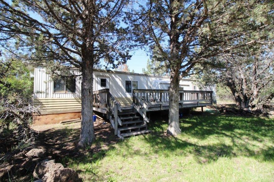 Nice older manufactured home, Keep or it would make great building site. Nicely treed acreage close to town. Private area, watch the wildlife play. Family room added to home. Great Value.