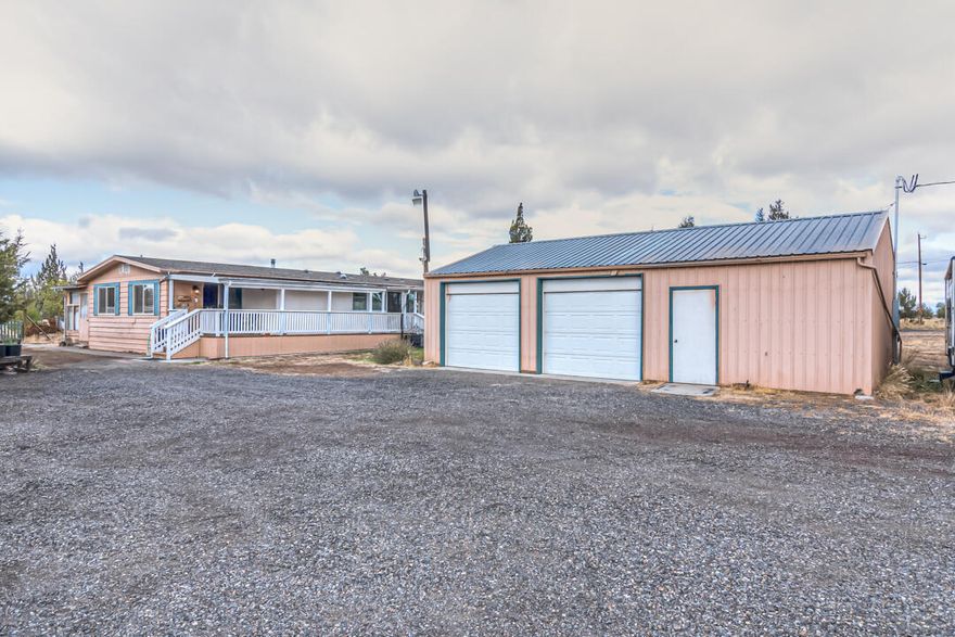 Opportunity awaits with this 1680 Sq Ft manufactured home on almost 2 acres. Corner lot provides great space and extra privacy between neighbors. Roof is less than 6 years old, Heat Pump for those hot summer days and a 2017 certified wood stove for the blustery cold ones. 3 storage sheds, carport, and a very nice 24x36 shop, includes 2 bays and a nice, enclosed office space or workshop. Large, fenced garden area. Both bathrooms have been upgraded. This home has been loved and well maintained. It's a must see!