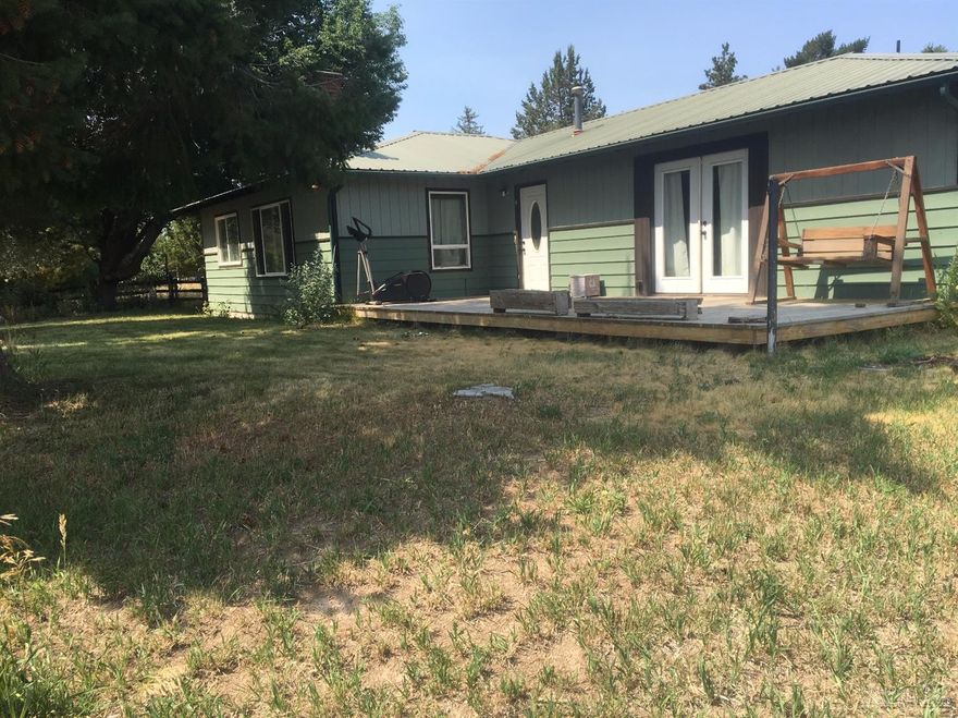 Situated on the edge of town, this 3 bedroom 1.5 bath home has a great location. 1700 sq feet of living space, family room, living room, dinning area, 3 bedrooms, 1.5 baths and a large utility room with lots of storage. Large deck for those great BBQ's. Mature trees, provide plenty of shade. Cover carport with 1100 sq ft of paved parking. Storage Building along with a small barn. Bring your livestock/Horses property also has 1.3 acres of Ochoco irrigation. Furnace and septic were replaced-June,2012