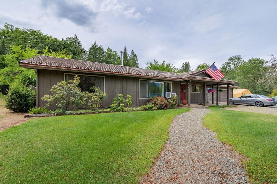 Meticulously maintained single level home features 3 bedroom 2.25 baths on 1.57 acres near the popular area of Murphy, Oregon.  Private setting, all the rooms in the home are spacious with an oversized 2 car garage. Roomy master bedroom with dual bath sinks and large closets. Oversized 2nd bedroom and the 3rd bedroom is a perfect office or spare room. Laundry room is conveniently located inside near the kitchen.
Nicely landscaped and completely fenced. Large garden area with fruit trees and irrigation available below the irrigation ditch. Space for RV with water/septic and electricity. Metal car or RV coverings. Storage shed. This treasure is ready for all the delights of the small farm or family home lifestyle.