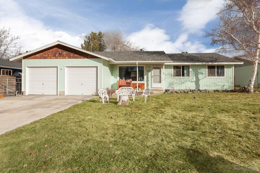 This spacious home has everything you need! 3bd/2ba w/open floor plan, vaulted ceiling, bar/island in the kitchen gives you plenty of room for entertaining. Wood fireplace will keep you warm the rest of the season. Fully finished garage w/2 automatic doors. RV parking and large gravel area in back provides plenty of space for toys! Storage shed in backyard, landscaped with fruit trees, grapevines, raspberry bush and much more! Relax on the covered porch in the hot tub! Must see home!