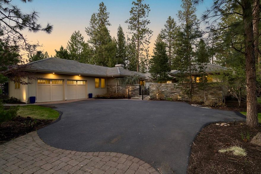 Privately tucked among the pines overlooking the Broken Top Club golf course, sits this coveted single level custom home that seamlessly blends warm ambiance and luxury. Beyond the secluded front courtyard gates, natural light invites you into the open great room anchored by a stunning stone fireplace. Timeless quality finishes are coupled with numerous recent updates throughout. The ideal floor plan has separation of the primary suite and adjoining office with fairway views from the guest wing that includes a second ensuite bedroom plus third bedroom with fireplace and built-ins adjacent to a third full bathroom. The grand kitchen equipped with new professional appliances and Butler's pantry and the expansive covered rear deck overlooking the trees and course lend to easy entertaining and indoor/outdoor living. This desirable location in the westside of Bend provides convenient access to outdoor recreation, shops, dining and top rated schools. A perfect base camp for your lifestyle!