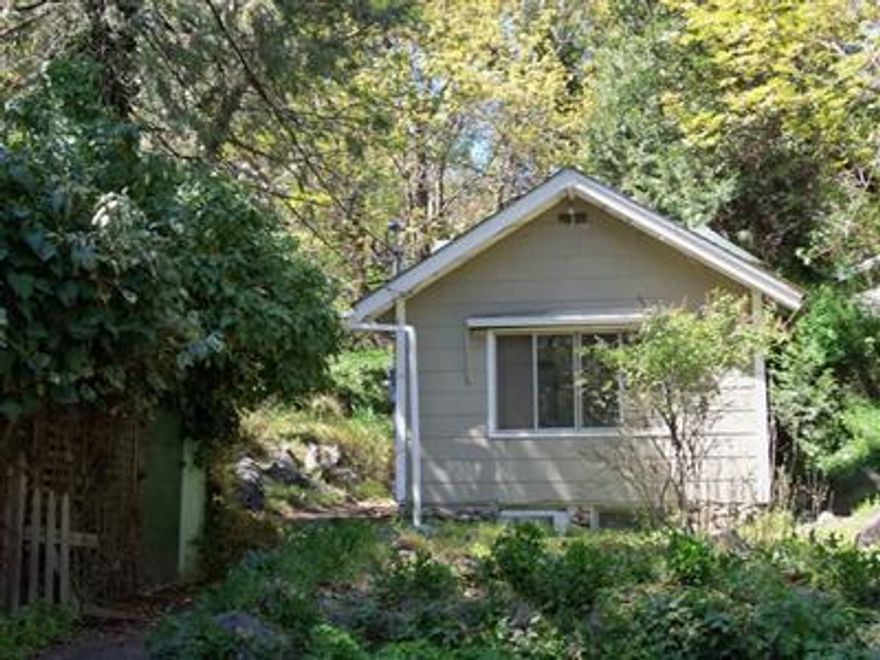 .17 acre lot that sits well back from the street across from Ashland's jewel, Lithia Park. A great wooded setting and close proximity to town and all the amenities Ashland has to offer make this lot a great place to live! Currently a 1920 year built, 2 bedroom, 1 bath rustic cottage sits on the property. Either tear down and start fresh, or you can work with what is there. The possibilities are endless on this hidden jewel. Buyers to do their own due diligence.