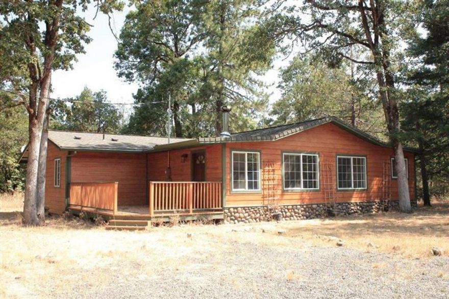 Quiet country living on 5 acres! Property is level & very usable for animals, gardening & much more. Site built 4 BR, 2 BA home originally built in 1975 & remodeled in 2009. Remodel included new sub-flooring for the new tile & laminate in the living areas, new insulation in walls & ceiling (Seller says it makes it easy to heat just using the wood stove in winter if one desires & stays comfortable in summer). Subsiding, Cement Board Siding (like Hardie Plank), Paint (finished to look like natural wood grain) Windows, Front Deck, Well Pump, Hot Water Heater & River Rock Accents. Vaulted Ceilings & Lodge Pole Beam Accents in both L/R & Master B/R - Master has walk-in closet & master bath; & sliding door leading out to private deck. Heating is convenient zonal heating & great wood stove. Good well per owner. Property in an eligible area for 100% financing - Call for more information.