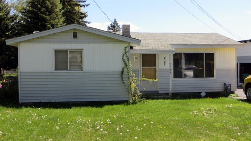 Here's a nice suburban location on nearly a half acre. This three bedroom, 1 bath home has vinyl siding, hardwood floors, includes all appliances and even the washer and dryer. There's a large 3-car detached garage (two open bays and one with garage door). This building includes a nice sized shop. There's a very large paved area for loads of extra parking. The back yard is totally fenced and has irrigation with pump included. The home in back has no value and is being sold in it's as-is'' condition to be used as a storage unit.