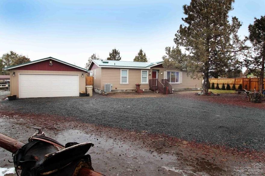 Price Reduced - This updated 3 bedroom 2 bath home lives LARGE. It boasts all brand new flooring in the living room, dining and hall. This turn key home is one to see. New energy efficient heat pump, new ext. paint on long lasting cement board siding. Guest bath has new tile floor, skylight, vanity and light fixture. The kitchen shines with all new stainless steel appliances, while the skylight adds an abundance of natural light. The master has large walk in shower and closet and is separate from the other bedrooms. There's also a new metal roof on the house and the double garage. This large 1.43 acre lot is fenced and xfenced. Currently set up for horses or create a masterpiece garden. Open riding just minutes away. An insulated 10x20 tack room (negotiable) makes life easy. 2 paddocks, a 12x20 hay shed, 16 ft gate will assure your animals & kiddos are safe at all times. Community pool, park, tennis, restaurant/bar and award winning golf course. Did I mention Mt.Jefferson views!