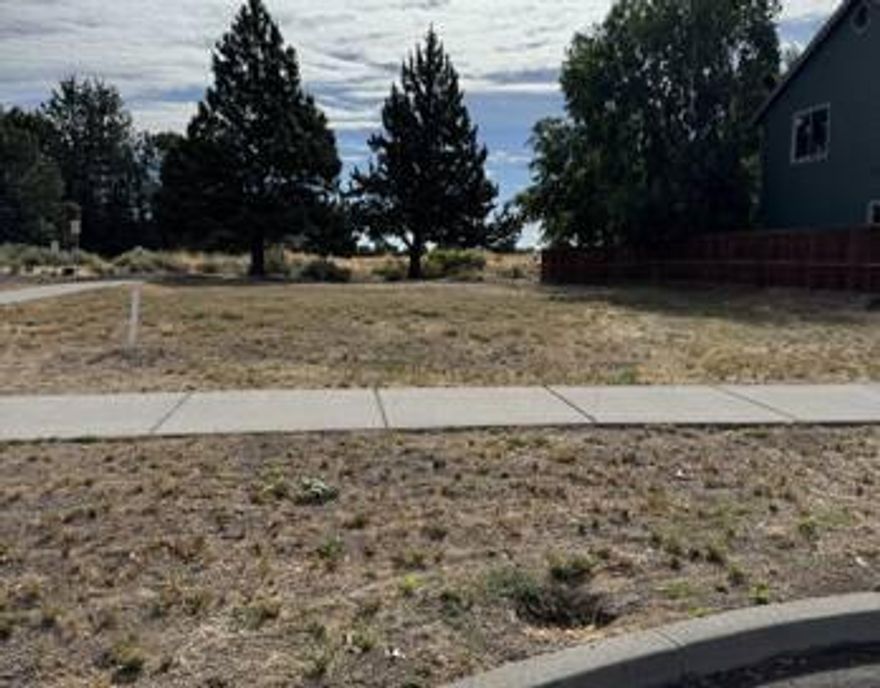 Beautiful flat city lot with utilities at the lot.  Property backs to the canal and Bend Parks and Rec has a proposed park for the property on the other side of the canal (which is directly behind the lot).  Lightly treed and with NO HOA.  Plans available for an additional fee.