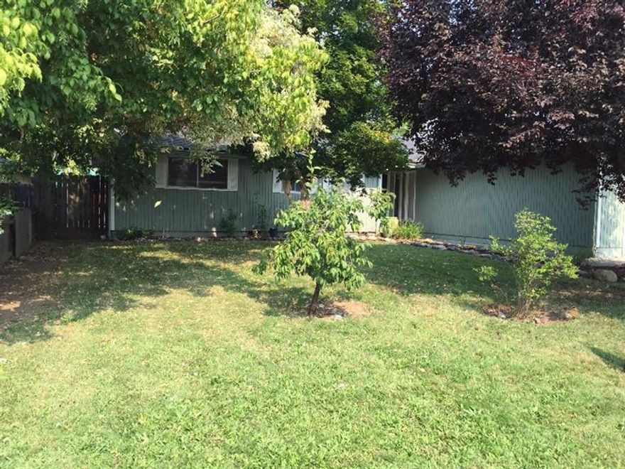 Single level home in a desirable Central Point location. Featuring 3 bedrooms, 2 baths and lots of natural light. There is a nice open living space and you can curl up in front of a real wood burning fireplace. Ample back yard is perfect for dogs or chickens, and with some work has great gardening potential. There is a peach, cherry and fig tree in the back and raised beds that have been used for organic gardening only, so with a little work you can enjoy food from your own yard next year. The front yard has large shade trees and and a plum tree. The quiet street is great for kids or just peace and quiet without the traffic one gets on a thru street. Bring your paintbrush and make this place your own.