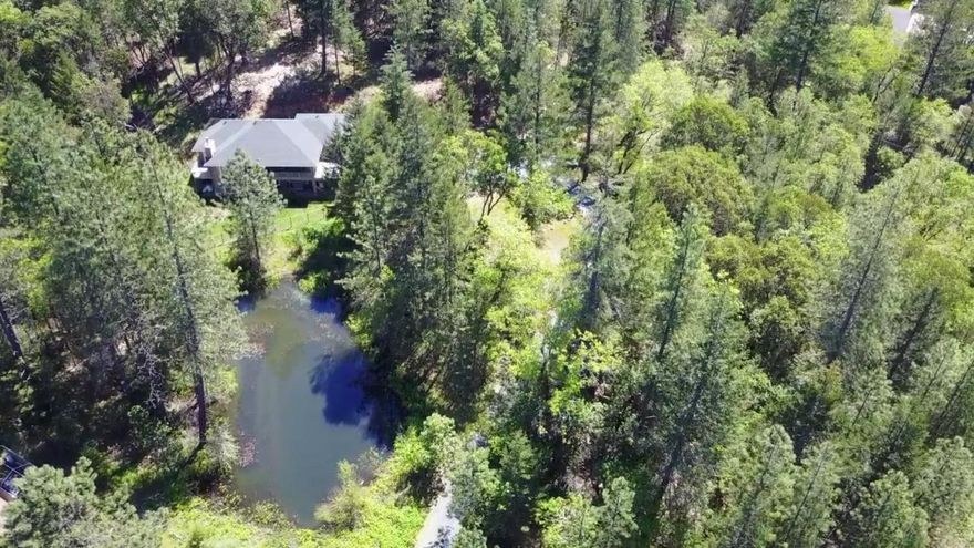 Built by homeowner and tucked away this beautiful custom built home with two ponds. All living area is on the main floor with master bedroom and bath, porch overlooking your private pond, living room, nice open kitchen with Granite and cultured marble window sills throughout and in showers. Oregon Marble Fireplace keeps you cozy along with Heat Pump. This home has additional living area below with two more bedrooms. Room for Pool table and desk area. Over-sized garage, private gate to property and did I mention two ponds? They are seasonal however main pond can be year round with diverter from the well to keep it full. Property has water filtration system, custom accents throughout and a very usable floor plan. Call to view. Virtual tour available. All information deemed accurate but not guaranteed and subject to change at any time. Buyer to perform all their own due diligence. Home Warranty through First American.