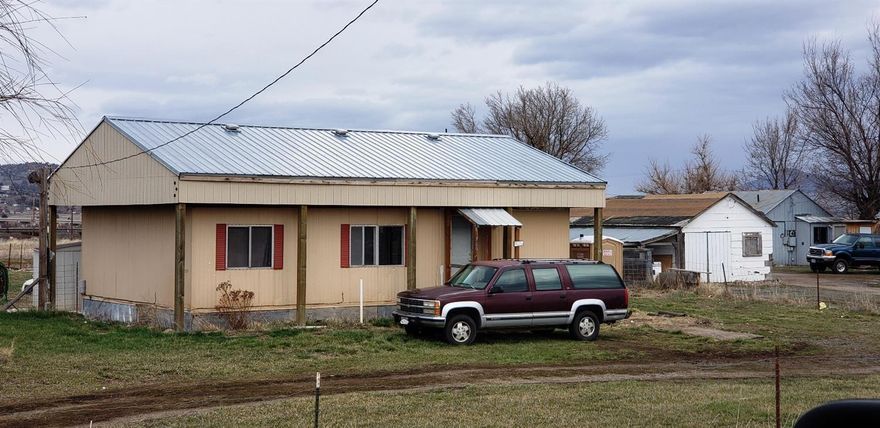 Live or invest in the country. Nice half acre lot with 1972 double wide manufactured home south of town. Needs a sand filter septic system and home needs attention. Priced to reflect this.