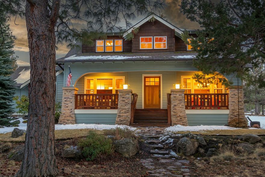 Nestled in the heart of Awbrey Butte, this exquisite Craftsman home offers timeless charm and modern comforts on a private corner 1.04-acre lot. Beautiful oak hardwood floors and quarter-sawn oak cabinetry enhance the warm and inviting interior, while the gourmet kitchen boasts granite countertops and Dacor oven & stove. The kitchen seamlessly opens to the spacious living room, where built-in cabinetry and a gas fireplace create a cozy and inviting atmosphere. The main-level primary suite serves as a serene retreat with its own gas fireplace, a luxurious soaking tub, and heated bathroom floors. Upstairs, you'll find three additional bedrooms and a generous bonus room, perfect for a media room, playroom, or home office. Enjoy outdoor living on the charming wraparound porch or unwind by the picturesque waterfall and pond. A rare 4-car tandem garage provides ample storage for all your needs.