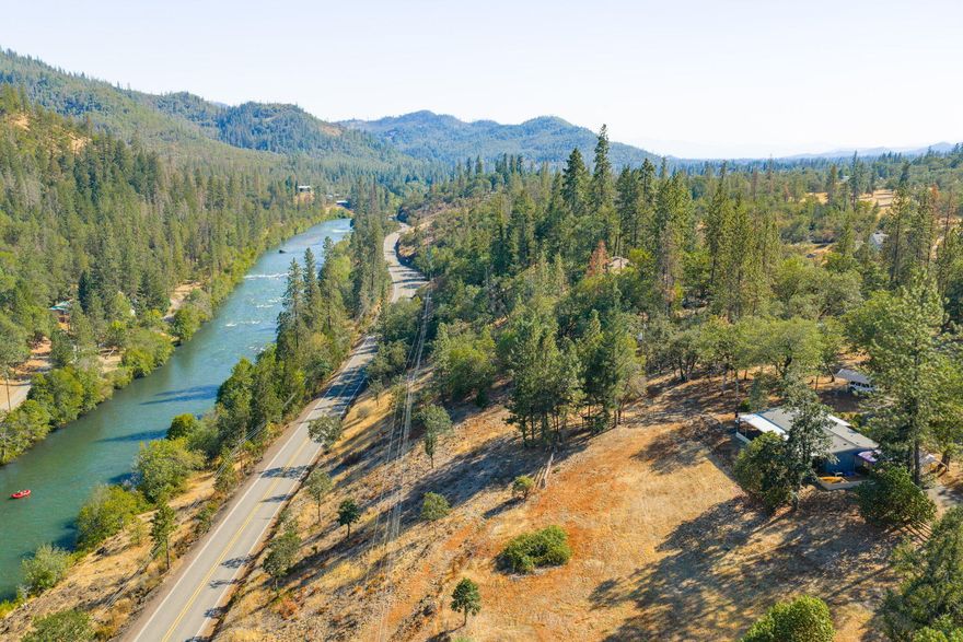Secluded & peaceful 10 acres overlooking the Rogue River. Over 500 feet of waterfront for access to great salmon & trout fishing. 2 bedroom, 2 bath & 1248 SF double wide manufactured home that has been completely renovated inside & out. New roof in 2024, new Milgard Low E windows, new insulation, dry wall, paint, flooring, kitchen & baths. Central heat & AC, ceiling fans plus a certified wood burning stove. Wrap-around deck with hot tub & gazebo to relax & take in the serene mountain & river views. 1500 gallon septic pumped in 2024.  Shared well with one neighbor (TL 907) tested at 40 GPM (2015). Large, fenced area perfect for a dog run or raised garden beds. Detached garage, detached carports, circular driveway & plenty of room for RV parking & boat storage. Electric security gate. Marketable timber w/ Oak, Pine, Douglas Fir, Manzanita & Madrone trees. 20 miles to Medford, I-5, airport & Crater Lake National Park is 40 miles away. OSR Zoning. Appointment only.