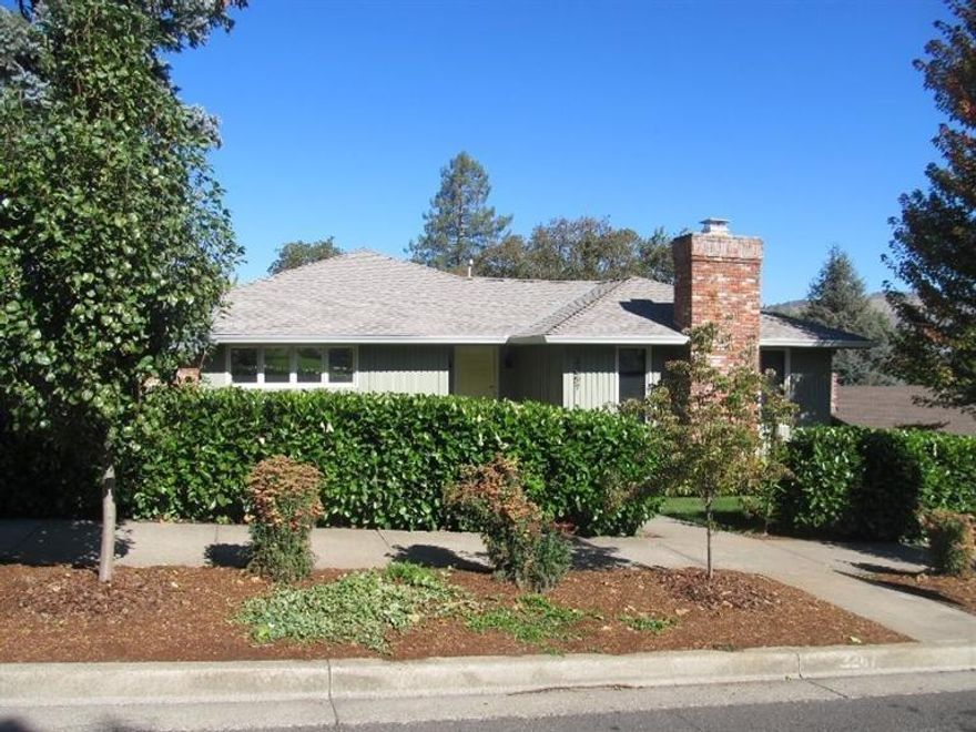 Great 4 bedroom, 3 bath home situated in an established East Medford neighborhood! Features include living room with hardwood floors, window seat, gas fireplace, open beam ceiling, beautifully updated kitchen with granite counters, subway tile backsplash, stainless appliances and skylights. Also on the main level, you'll find a sitting room with gas fireplace, spacious master bedroom with his and hers walk-in closets, an additional bedroom and updated bath with porcelain tile flooring and tub surround and limestone vanity top and the deck just off the dining area that takes advantage of the views of Roxy Ann. On the lower level there are two additional bedrooms, one with its own bath, the other that accesses the screened in porch which leads to the very private backyard. Located in the desirable Lone Pine School District!