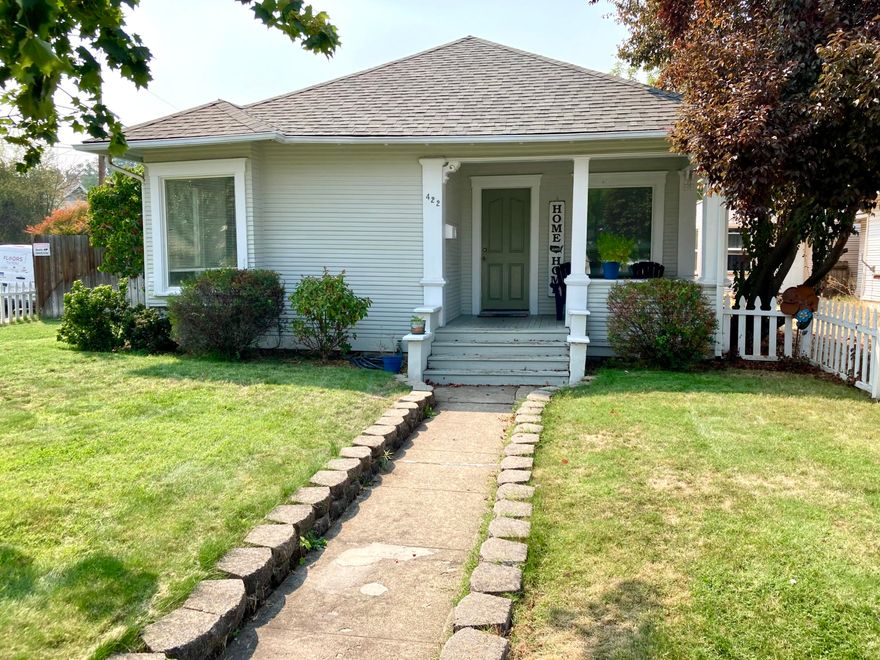 This classic craftsman style cottage on a corner lot w/fantastic curb appeal sits on a peaceful street in West Medford and comes turnkey for it's new owner. From the moment you walk through the white picket fence, manicured yard and up to the covered front porch, the charm is simply breathtaking. Upon entering you're greeted w/beautiful wainscoting, fir flooring and a calming color scheme in what the sellers currently use as a spacious dining area w/the living room (previously a formal dining room) and 2nd bedroom off to the left. Continuing straight through, you are drawn to the most adorable kitchen w/vintage cabinetry, good counter space and a huge walk-in pantry. Next to the pantry off the kitchen is the main bathroom w/a claw foot tub and pedestal sink adding to the charm. You'll appreciate the spacious master bedroom and laundry room that doubles as a mud room with access to the 3rd bedroom and access to the private yard with patio, fire pit and access to the garage/workshop.