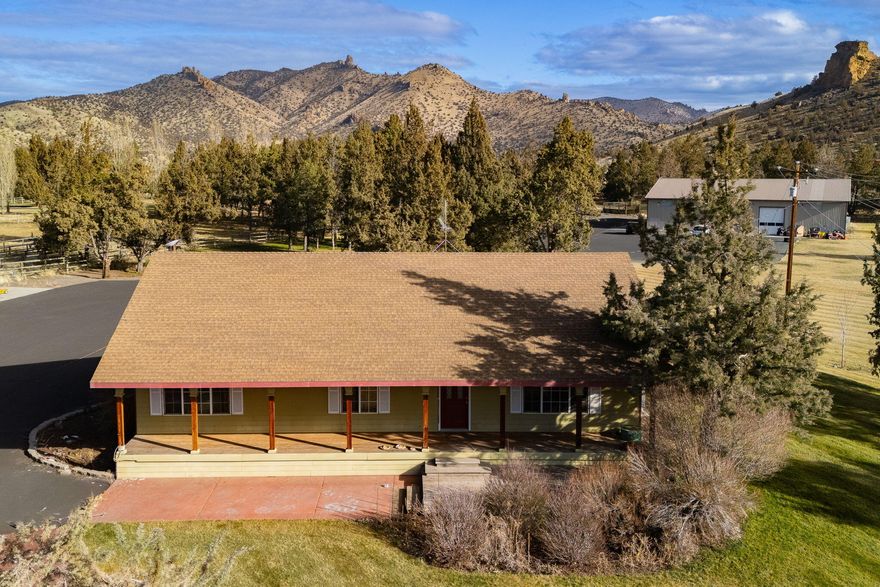 Stunning horse property w/unmatched views & endless possibilities! Nestled between breathtaking views of Smith Rock & the majestic Cascade Mountains, this property offers a rare blend of natural beauty & functional amenities. Enjoy 12 acres complete w/10 acres of water rights, ideal for equestrian lovers & outdoor enthusiasts alike. Equestrian facilities include a 2,976 sq ft barn w/4 stalls, 4 runs, a heated tack room, & comfortable living space w/a bathroom above. The outdoor 180'x100' riding arena has views in every direction. There is in-ground irrigation & an automatic pond fill/overflow system for convenience & sustainability. Property also includes an expansive 8,000 sqft, 2-story shop w/epoxy floors, office spaces, industrial HVAC, & 3-phase power — the perfect space for work or hobbies. Fully fenced & cross-fenced, w/lush pastures ready for grazing. Whether you're looking for a peaceful retreat or a fully equipped equestrian estate, this property offers it all.