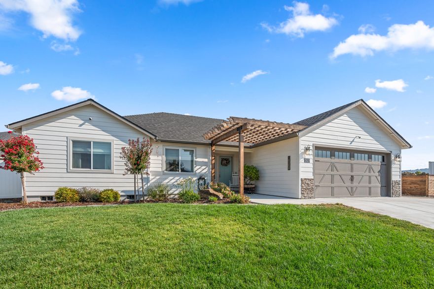 Custom crafted 3BD/2.5BA home in desirable E. Medford location. With thoughtful interior and exterior upgrades, and lovingly maintained by a single owner, this house shows better than new! You will be greeted by an open concept floor plan which features LVP flooring and vaulted ceilings. The kitchen is spacious and comes with quartz countertops, soft close cabinets, pull out drawers and a lazy susan in the lower cabinets. Both bathrooms are spacious and have custom tiled showers and matching quartz counters. The primary bath has dual vanities. The second bedroom has an attached bath with an extra-large closet making it perfect for guests or multigenerational living. The third bedroom features stunning mountain views and works great as an office space. Outside you'll find extensive upgraded landscaping including custom pergolas, two large sheds and a gas stub for your barbeque.