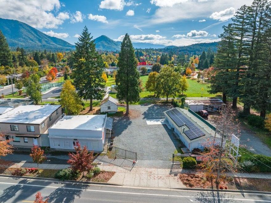 Owner Carry Possible! Great opportunity with this large 0.48 lot featuring 2 main buildings with Rogue River Hwy frontage. 1493 Rogue River Hwy is 1940 sqft & has potential to be split into two separate units. 1489 Rogue River Hwy is 1950sqft block construction with an office & two separate garage spaces. There is a detached shop in the back of the property as well. Some other features include, separate power meters with solar , 2 wells, & fully fenced with a new gate! Come tour this one before it's gone!