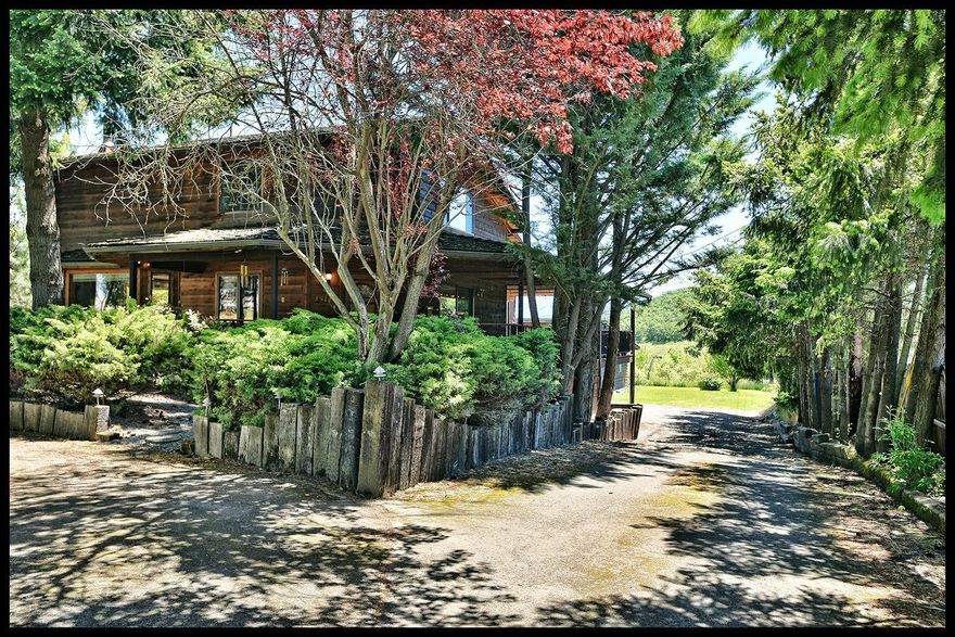 Unique opportunity! Amazing spacious cedar home situated in nearly an acre of irrigated land! This home boasts large rooms throughout with tons of storage. There are beautiful hardwood floors throughout the main level, custom oak cabinetry, 2 huge decks for outdoor entertaining. The kitchen boasts dual wall ovens, 5 burner gas cooktop, trash compactor, eating bar and large pantry storage. The master en suite features a walk-in closet and several additional large closets, dual vanities, granite counters and a jetted tub with tile surround. Additional 3 bedroom are roomy, 2 feature separate playroom/sitting room areas. The laundry room has many cabinets and a utility sink. Outdoors you will find mature landscaping with wonderful shade trees, vast lush grass areas and a pasture. Views clear to Mt. Ashland! Large shop with 3 parking bays. This home is a real surprise! Feels like you are in the country but walking distance to schools, medical care and athletic clubs!