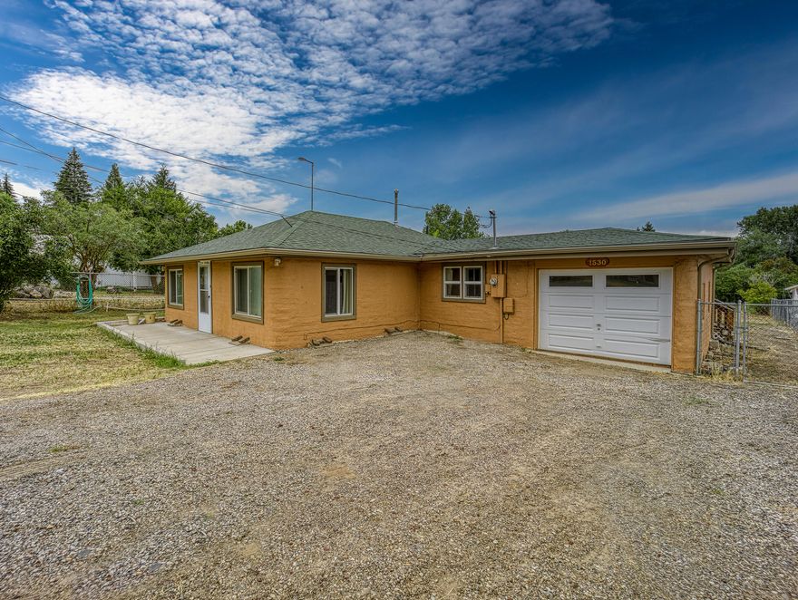 This 3 bedroom, 2 bathroom home sits on a large 0.34 acre lot on a dead end street. The interior features newer flooring, windows, and kitchen cabinets. The back yard includes a cozy covered deck which overlooks a large fenced back yard and mature trees. There is a 1 car garage and a large driveway for plenty of parking. Property has irrigation.