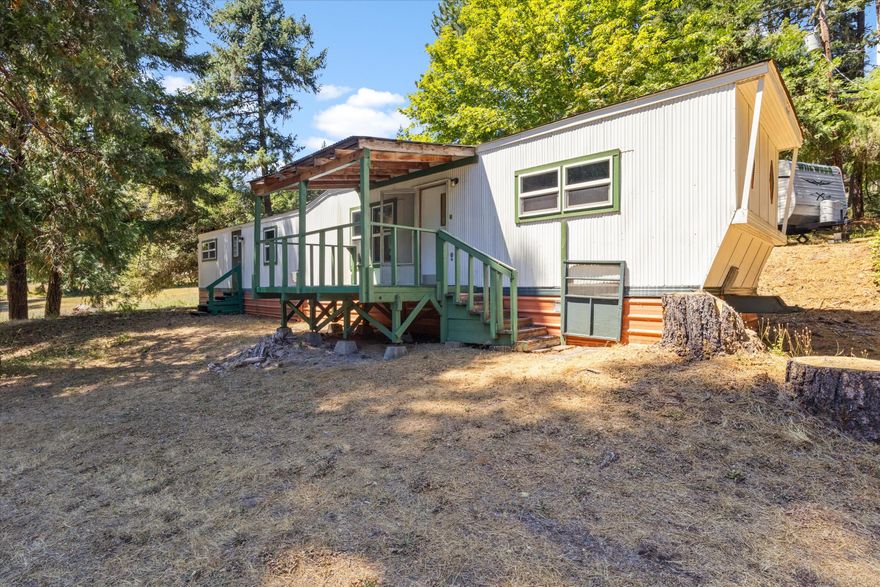 Escape to the peaceful beauty of Glendale, Oregon with this affordable country retreat at 2899 Reuben Road! Nestled on a private, tree-shaded lot, this vintage manufactured home offers rustic charm and endless potential. Featuring a covered front porch, level yard space, and serene forest surroundings, this property is perfect for nature lovers, homesteaders, or those seeking a quiet getaway. Enjoy the tranquility of rural living while still being just minutes from town amenities. With some updates, this could be your ideal Southern Oregon escape. Don't miss out—schedule your showing today!