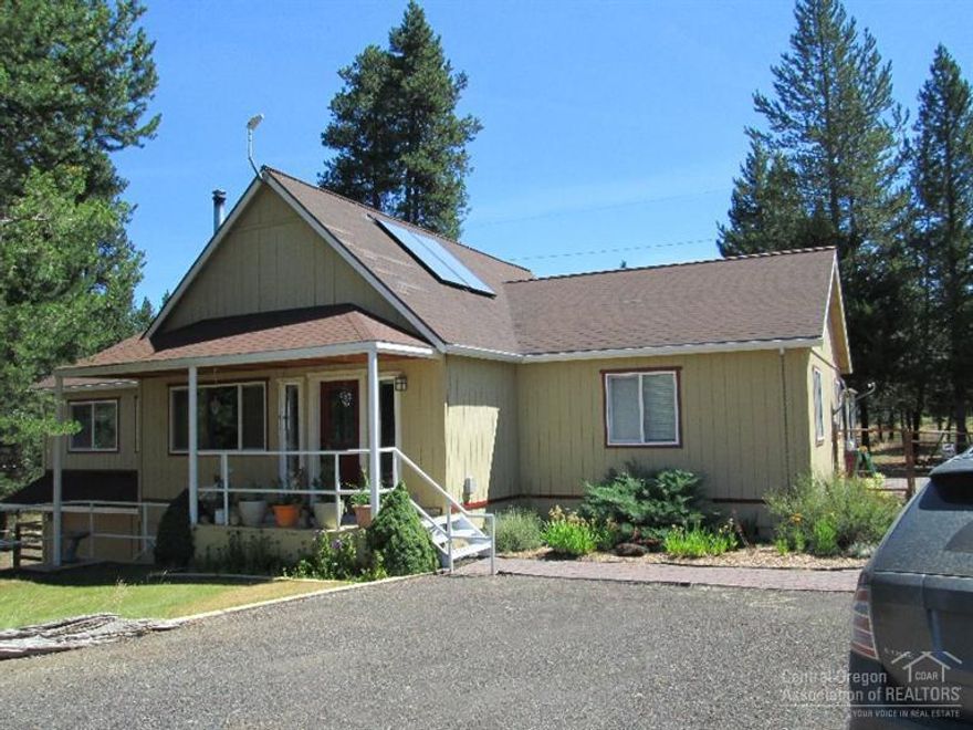 Beautifully kept & updated home across the road from the Little Deschutes River. 1823 SF, 3 bed, 2 bath, w/vaulted ceilings, granite countertops, SS Appliances included, including washer/dryer. Separation of bedrooms, office also located privately & has tons of natural light. Wood stove supplements the heat pump/AC, solar powered hot water heater & classic charm thru-out. 2 car garage, lg shop, greenhouse, outdoor kitchen, patio, barn/shop & completely fenced & gated. Adjoins public land.