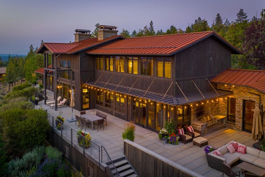 Located on a premium lot in North Rim with panoramic views of the Cascades,
this architecturally significant NW Contemporary is a stand alone
masterpiece with a timeless design that 
embraces the external beauty of the surroundings while offering breathtaking
views from nearly every room. Soaring ceilings, expansive windows, rich hardwood beams and extensive stonework create a
warm, sophisticated atmosphere that inspires a harmonious connection with nature.
Enjoy upscale gatherings in the awe-inspiring kitchen that opens to an
expansive deck, drenched in scenic landscape, with impressive outdoor
fireplace and seating area. Celebrate in the formal dining room accented with elegant cabinetry and serviced by a Butler's pantry.  Relax in the gorgeous Primary Suite
with Luxury Bath and grand
closet. Three additional bedrooms w/ensuite baths, two private studies, a
Bonus Room, a 1200 bottle wine cellar and an extra large 4 car garage make this your Central Oregon dream come true!