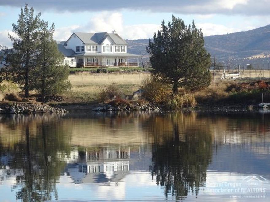 In desirable Powell Butte community on 98 ac, 64 irrigated, is a beautiful 4 bedroom, 2.75 bath, 2848 sq ft home with a wrap around porch, oversized 2 car garage, shop & hay barn with lean-to. This property is fenced and cross fenced. Bring your fishing poles, included is a portion of a beautiful lake with well developed fishing habitat for outstanding bass fishing (5 & 6 lb lunkers), 2 irrigation ponds, great for goose hunting. The waterfowl population is tremendous. Watch them land on the lake every night. Bring your .22 for great rockchuck and sage rat hunting. Enjoy the large deer population that roams through. This property is down a long lane with country quietness and peaceful surroundings. There are outstanding views of 8 Cascade Mtn. peaks, Smith Rock, and Ochoco Mtns. Enjoy coffee on the porch and watch the sun rise over the Ochocos or at the close of a day, the sun setting over the lake and the gorgeous Cascades. Come ranch, fish, hunt, ride and enjoy life in Powell