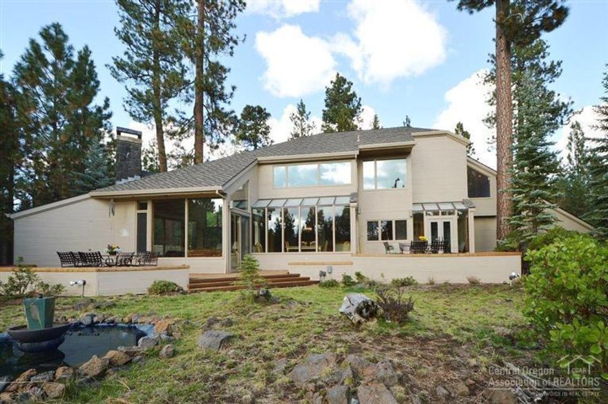 A premier home at BBR. Secluded. Huge lot at 1.71 acres. View of the 3 Sisters mtns. and Broken Top. Home is at the end of the cul de sac to the left, hidden in trees. Super efficient floor plan with 4 bedrooms and a balcony loft-sitting area (could be used for extra sleeping arrangements). In addition to the 4 bedrooms there is a dorm up over the garage. Great room features huge rock fireplace and beautiful wood floors. Big deck, hot tub, double garage, water feature to the west, natural landscaping.