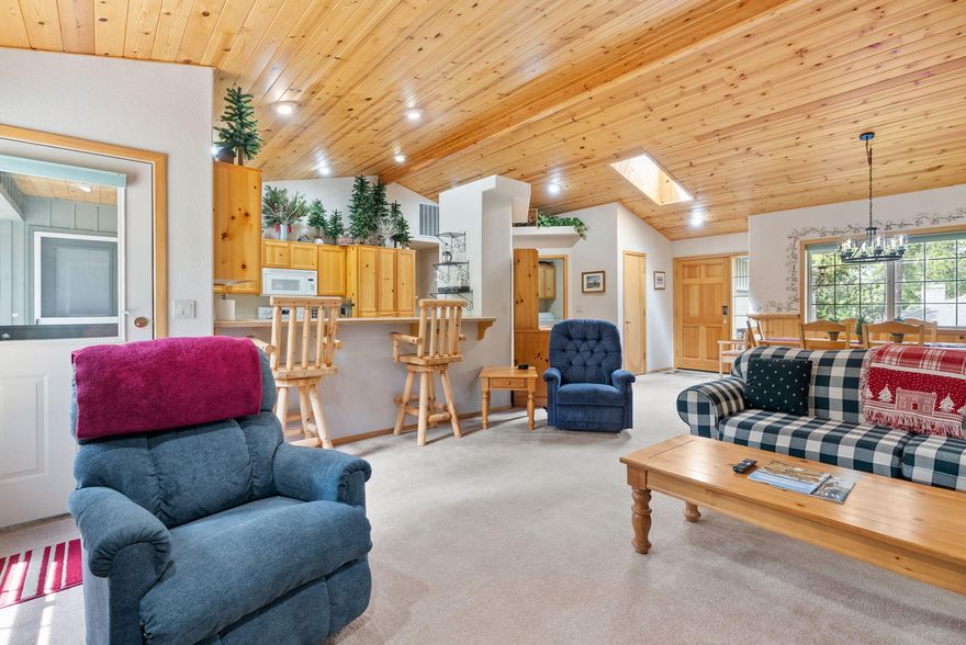 Escape to Sunriver in this inviting 3-bedroom, 2-bath single-level home nestled on a peaceful, wooded lot. With classic Northwest charm, this well-maintained vacation rental features beautiful knotty pine ceilings, a cozy river rock fireplace, and a flowing, open-concept layout that's perfect for gathering with family and friends.  Enjoy the serenity of the private back patio, ideal for morning coffee, or relaxing under the pines. The roof and water heater were both replaced just six years ago, adding peace of mind for future ownership. Whether you're looking for a turnkey vacation rental, second home, or full-time residence, this Sunriver gem offers comfort, character, and the perfect Central Oregon setting.