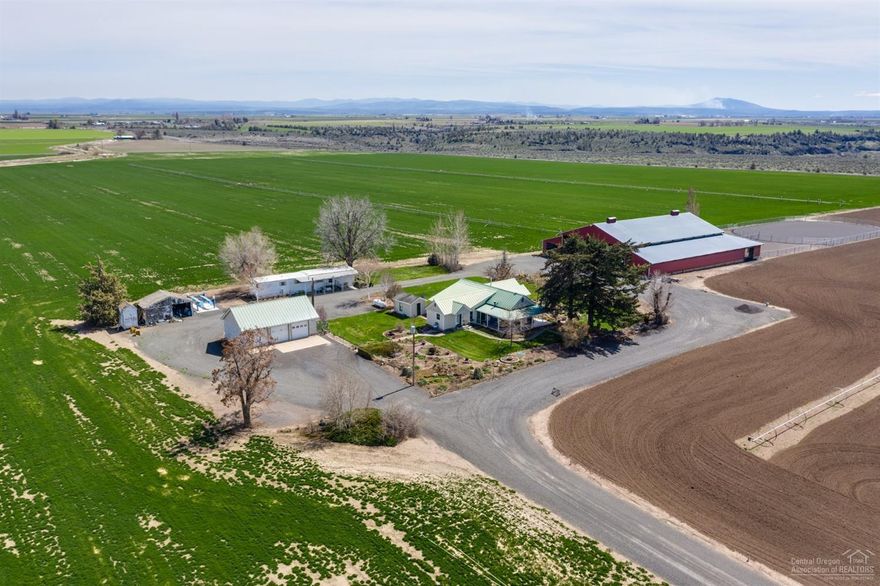 Unparalleled 360 Degree views of 9 mountains from this prime horse/farm estate; Jefferson, Mt Hood, Black Butte, Cascade Range, Mutten MNT's! 12,800 SQFT Outbuilding; equipped w/ 7-matted-stalls & tac rm w/hot water; & 220 power. Deschutes water; 144.5 acres of, N unit, irrigated, LEVEL farm grnd! Wheel lines & hand line irrigation equipment included! 2 dwellings; Farm house (2 bedrm- 2 bath & office) & 1975 mobile home; & divisibility potential too! 100' X 165' Riding Arena w/ galvanized steel panels. The farm house has been maintained-well & is move in ready! This property has it all! Listing agent is related to seller.