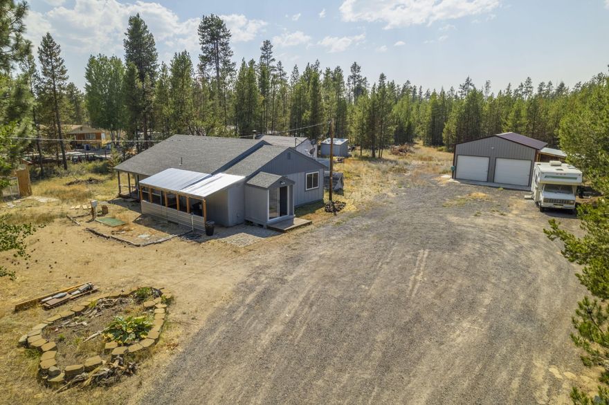 Welcome to this updated home only 3 minutes from HWY 97 and La Pine! This property offers 3 bedrooms and 1 bathroom on 2.38 acres that is fully fenced. The house has new interior/exterior paint, new carpet, triple paned windows, and a new ATT Septic System installed 2019 with an annual maintenance agreement. The kitchen has laminate counter tops with two entryways to the spacious living room. One of the bedrooms has been used as an office with a built-in desk and a new barn door. Down the hallway you have a full bathroom with a new vanity installed in 2021. The second bedroom boasts natural light and has a private door to the front covered patio. The main bedroom has a walk-in closet with a slide-door to the backyard. In the backyard you have a chicken coop with heat lamps and a heated watering system. The main shop has two 8ft high garage doors, electricity, an air compressor hook-up, and is fully insulated with a heavy-duty roof. Come check it out today!