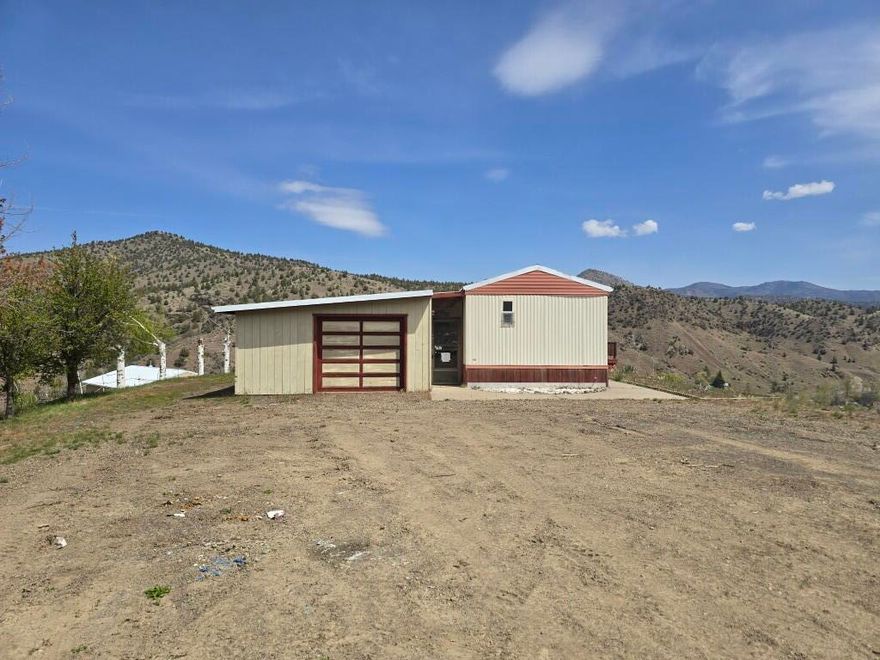 Don't miss your opportunity to live your best life in Mitchell, Oregon on this great property with over 7 acres and a stunning view! Situated close to the Painted Hills, the John Day Fossil Beds National Monument, and the beautiful Ochoco Mountains. This property features a 3 bedroom, 2 bath manufactured home, a 450 sqft garage and 1440 sqft shop built in 1998. Call your favorite agent today to schedule your private tour!