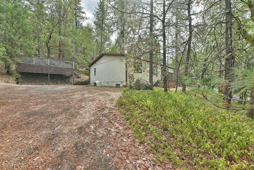 Welcome to this 3 bedroom 2 bath home surrounded by trees and wildlife! Inside you will find a nice open and split floor plan. Wood burning stove for those chilly winter mornings ahead. All the bedrooms are great size! Nice little diamond in the rough. Needs some TLC.