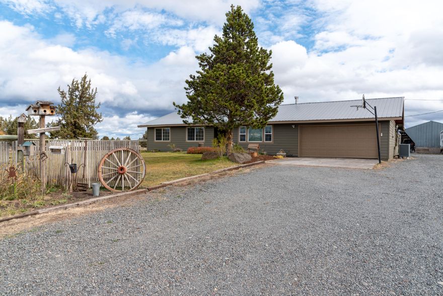 Horse property in SE Bend great country neighborhood 10+acres with Mtn. views! Single level home with 2289 sq. ft., 3 bedrooms plus office with walk in closet, 2 baths, living room with woodstove, barn door entrance to family room, large utility w/sink, cabinets & closet. Spacious kitchen with custom cabinets, pantry, eating bar & extra sink. Vaulted primary bedroom suite with walk in closet, bath, bedroom separation & door to backyard deck. Home has central vacuum, storage, garage, metal roof, fenced backyard, hardi-plank siding, new exterior paint 2021, new furnace & heat pump in 2017. Outside features a solar gate entrance, pond with 2.75 acres of underground timed Irrigation, fenced & cross fenced, 36x48 4-stall barn w/tack room, chicken coop, 24x32 3-sided shop, 12x12 insulated dog kennel w/2-6' high dog runs, fenced garden area with raised beds & property borders Park & Rec land for easy access to ride, hike or bike. Includes buyer home warranty, larger than looks not a drive by.