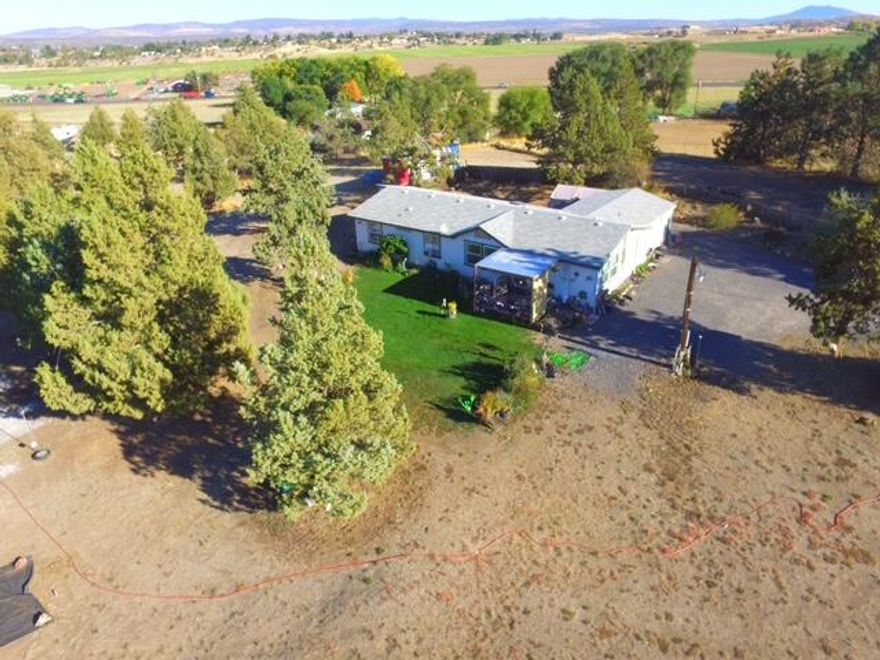 Experience serene country living and mountain views! Nestled on a gated and fully fenced 3.26 acre parcel, this spacious 4 bedroom, 2 bathroom home offers the perfect blend of privacy, comfort, and functionality.  With 1,728 sq. ft. of well designed living space, this open concept floor plan offers features that include vaulted ceilings, skylights and a light filled interior that creates a warm and welcoming atmosphere.  Additional highlights include an attached two car garage, central air conditioning, and ample space for a custom shop, horses or your dream outdoor setup.  Whether your seeking a peaceful retreat or a property with room to grow, this Mountain View gem is ready to welcome you.