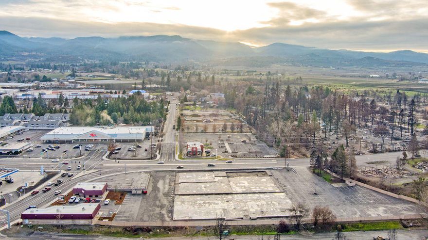 The former Pacific Plaza, which was destroyed by the Almeda Fire of 2020.  The main building structure destroyed was over 40,000 Square Feet. The site improvements are in place i.e., water, sewer, natural gas, electrical, storm drain system, cable/phone, fire sprinkler system water line, site lighting, asphalted parking area & concrete slap/foundation. A local Engineering Firm has indicated the concrete slab/foundation may be usable for a to be built structure.  There may be an opportunity with City approval to capture savings based on Building Fees & System Development Fees already paid.  Buyer to do their own due diligence in- regard to capturing Fees paid. There is a Center Pole sign on the S. Pacific Highway side of the property, which could be adapted to a new Center. Access to the property is a right in/out from Fern Valley Road and left in/out & right in/out from S. Pacific Highway.  There are 2 concrete masonry buildings with metal mansard, currently occupied by 3 tenants.