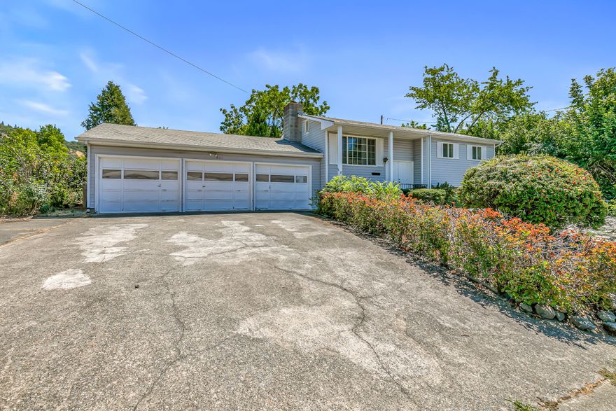 Great opportunity to bring a lovely older home into the 21st century. Main level has 2-bedrooms, 1 bath, living room and kitchen, while the lower level has 2-bedrooms, 1-bath and a family room. The backyard a quite large with a chain-link fence around it. There is plenty of space for a large family. The above ground pool is included at no additional cost and enjoy a 3-car garage. Located near Public swimming pool, tennis courts and park as well as Grants Pass High School.