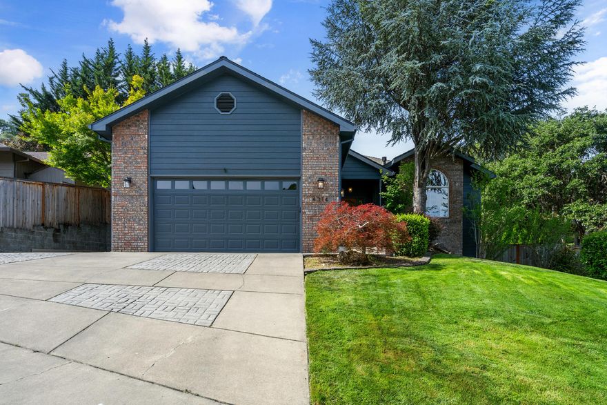 Back on Market, no fault of property. Charming East Medford Home with Exceptional Features! Nestled in a peaceful cul-de-sac, this beautifully landscaped 3-bedroom, 2-bathroom home offers the perfect blend of comfort and convenience. Step inside to a bright, open floor plan featuring a stunning remodeled kitchen with a huge pantry, large dining area, and modern finishes. Enjoy views of Roxy Ann from the spacious living room complete with a gas fireplace. The expansive primary suite offers a slider to the backyard, plus a luxurious primary bathroom with a large walk-in closet, double vanity, walk-in shower, and an oversized jetted tub for ultimate relaxation. A spacious laundry room with storage and a sink adds extra functionality. Outside, enjoy the large, covered patio, oversized 2-car garage, additional parking, and a workshop underneath the home.  This home is a must-see!