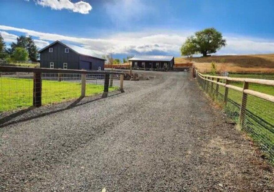 Dayville's Finest, Country Living At Its Best! Fabulous mt & valley views, newly constructed 1344 sq ft home features an open concept living, vaulted ceilings and beautiful Juniper accents throughout, kitchen features butcher block countertops, stainless steel appliances, open shelving & cabinetry, primary bedroom with en suite bath, 2 additional guest rooms of comfortable size, full bath, recessed lighting, luxury vinyl flooring, propane heat w/smart thermostat & central AC, energy star vinyl framed windows w/blinds, dining area w/slider onto patio, pantry, linen closet, utility room, tank less water heater,  covered front deck, back patio w/fire pit & privacy fence, metal roof, landscaped, rock retaining wall & sprinkler system, perimeter fenced, small irrigated pasture, circular graveled driveway, full RV hook up, nice large shop.  $365,000   (5 Star Airbnb Guest Favorite)