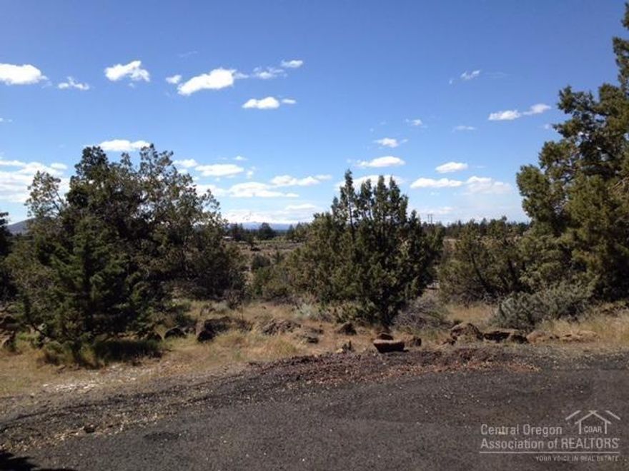 Three contiguous lots with panoramic views, from Bachelor to Mt. Jefferson. One of a kind building site on cul-de-sac, at the Dry Canyon of Redmond. Mobile on property has no value, new septic needed on one site. 2 building sites per county record, CLA re: septic feasibility study.