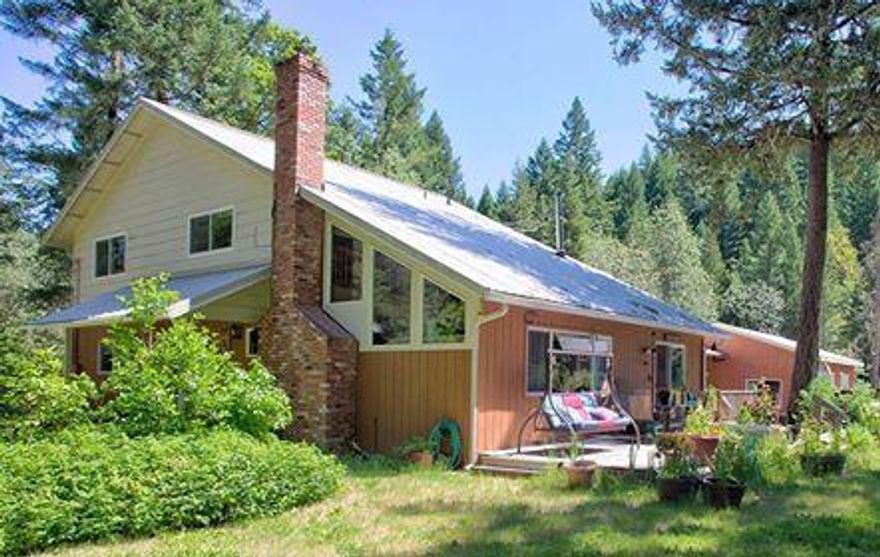 New Price! Motivated Seller! Awesome,large,home with five bedrooms (or four bedrooms and an office) in a beautiful and private setting. There's room for all of your toys, animals, and family in this wonderfully situated paradise. A truly unique home with tons of character, a great floor plan, lots of light, woodwork, and closets galore. They just don't make them like this anymore. Much updating throughout including the kitchen, bathrooms, flooring, and vinyl double pane windows. There's potential here for at least one additional dwelling unit utilizing the existing buildings (check with county planning for regulations). Outbuildings include a recently built three car garage, standard barn with loft, and a large storage building that was (rumor has it) the original home. Absolute quiet! Just 6.5 miles to the Selma Store and 21 miles to Grants Pass. Property backs to BLM, there may be marketable timber on the property, Survey on file with surveyor's office, Well recorded at 17 gpm in 201