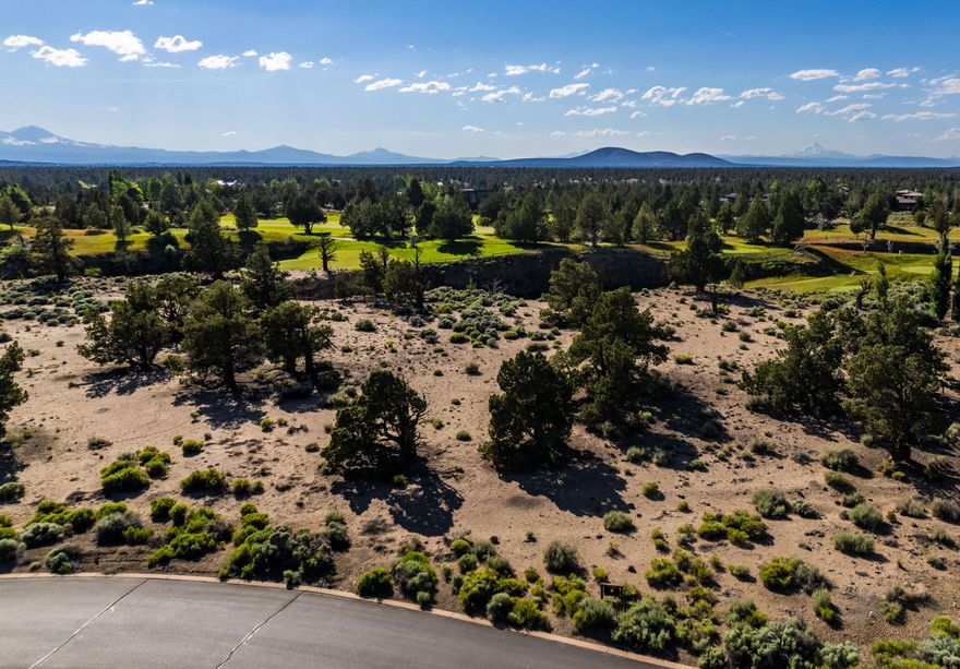 This exquisite, buildable lot offers stunning views of the signature eighth hole of the Tom Fazio Championship Course at Pronghorn Club and Juniper Preserve in Bend, Oregon. Residents will enjoy beautiful Cascade Mountain views, ample privacy, and a peaceful setting overlooking the picturesque par three and renowned lava tubes. This unique homesite is situated on a private cul-de-sac, providing an ideal location for your dream home.