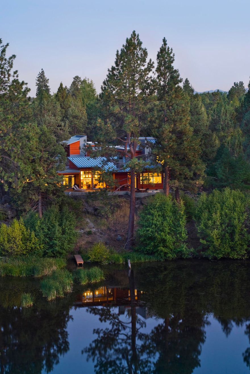 Take in breathtaking views from this extraordinary modern masterpiece perched above the river & a short distance from Downtown Bend. Enter through a lavish courtyard filled w/ native plants & stunning architectural style. A passive-solar design & towering windows fill the great room w/ light & captivating views that invite the outdoors in. A luxurious suite awaits in the North wing complete w/ 2 customized bathrooms, 2 walk-in closets, & gym. The South wing boasts 2 river view ensuites, & an office w/ phenomenal views. Take in nature from the expansive deck w/ multiple settings for entertainment & relaxation. Paddleboard on the river from the dock.  Meticulously maintained by the original owners, this home is perfectly appointed for a comfortable Central Oregon lifestyle. Some of the many features include Brazilian mahogany floors, 12-zone radiant floor heat, premium appliances, remote shades & windows, wine fridge, dumb waiter & greenhouse. A list of amenities available upon request!