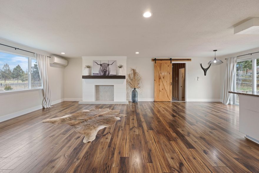 This one-level home offers 3 bedrooms, 2 bathrooms, and 1,820 square feet of living space. The original garage has been converted into a large bonus room with an office and laundry area. A new two-car garage has been added. The property sits on more than 4 acres and includes 2 acres of irrigation rights. A 36x48 barn features 5 stalls with outdoor paddocks, a tack room, a hay storage area, heated storage, and an office. Several irrigated pastures, a dry-lot area, and an outdoor arena are also included. The home was remodeled in 2020 and is suitable for equestrian use or agricultural activities.