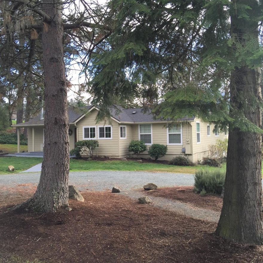 Wrap yourself in the rich warmth of country living in this beautifully updated and impeccably maintained beauty just a few minutes from the heart of downtown! Absolutely gorgeous kitchen is the heart of a convenient floorplan that caters to relaxing and entertaining in the living room with its solid wood floors and wood stove, then invites you to the ample dining area, and urges you on to the bright and cheery bedrooms and handy full bathrooms. Add to all this, nearly 500 sq ft of remarkably warm, finished, and usable basement with vinyl windows and it's own walk out access, and you have what many of us dream of! Hardi plank siding & vinyl windows. Through the dining room French doors, step onto the big new trex style deck with its gazebo, enjoy the two detached double garage sized buildings, large fenced garden area & mature orchard trees, and enjoy this very usable mostly level acre with some minor rolls for character, framed by mature trees and lots of inviting lawn.