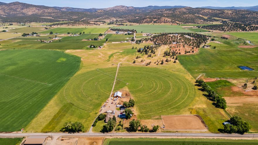 Welcome to your dream ranch in Central Oregon! Spanning 91.14 acres with 75.7 irrigated, this exceptional property features three homes, including a stunning 5 bedroom, 3.5 bathroom main residence. Enjoy rustic farmhouse charm with a spacious bonus room, breathtaking mountain views, and a picturesque driveway lined with apple trees. The property boasts a barn with stalls, two gravity fed pivots, a metal shed, and truck scales. Ideal for livestock and equestrian pursuits, the ranch includes a roping arena, manicured yard, and a 2 car garage. Two additional homes generate rental income, offering versatility and investment potential. Whether your seeking a private retreat or a working ranch, this property delivers the ultimate rural lifestyle with modern comforts and income opportunities. Schedule your tour today.