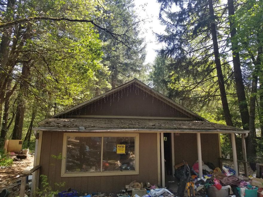 This home in Cave Junction is an investor's dream, For a rental property or to clean up for re-sale and equity. The home itself needs a little TLC and the land is flat and useable. The seller is Motivated so jump on this opportunity now with your offers. At this price with a cozy home with a third room that could be converted into a bedroom on a half an acre it won't last long. Come with your buyer's and offers today! Buyer's to do due diligence on full use of the property and all representations are deemed accurate but not guarantied