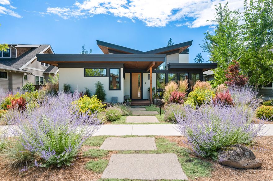 Located in Bend's coveted Discovery West, this architecturally stunning home by Leader Builders blends modern sophistication with timeless natural elements. Vaulted ceilings and expansive windows flood the interiors with light, while wide-plank oak floors and a dramatic triple-sided fireplace anchor the open living and dining areas. The chef's kitchen features quartzite countertops, custom cabinetry, and a sleek island with seamless flow to the patio and landscaped grounds with water feature, fire pit, and turf. The primary suite offers a spa-inspired bath with heated floors, walk-in shower, and generous closet. Two guest bedrooms, a stylish bath, and dedicated office add versatility. A 3-car garage with custom cabinetry, mudroom, and dog wash station.  Home may be sold fully furnished with high-end decor curated specifically for this home. Inquire for pricing on furnishings.