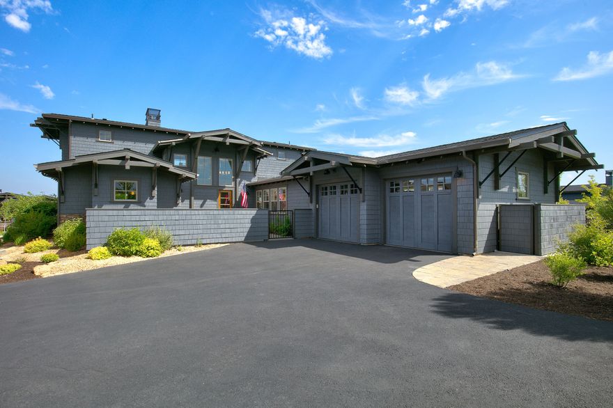 Discover the allure of this unique NW Contemporary home with an open floor plan and a luxurious main-level primary suite. The light-filled great room impresses with soaring ceilings and mountain views, a stone fireplace, and beautiful hardwood floors. A chef's kitchen features a granite island, quartz counters, Thermador appliances, and a large walk-in pantry. Step outside to the paver patio accessible from the dining area and primary suite, offering stunning Cascade and golf course views. Upstairs, two en-suite guest rooms connect via a sky bridge, each w/a private balcony to take in the mountains and golf course. The gated front courtyard offers a seating area and hot tub. Situated on a spacious corner lot in The Rim neighborhood of Tetherow. Attached 2 Car Garage. Enjoy easy access to community amenities, Phil's Trail network, Deschutes River, and Mt Bachelor road. A perfect blend of modern elegance and nature's splendor awaits in this remarkable home.